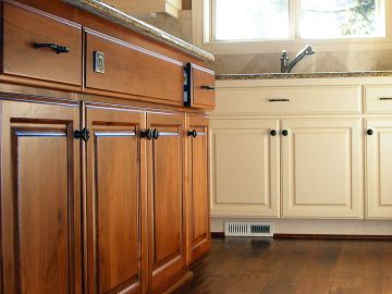 Andrade Painting & Decorating finishes cabinets in Walnut
